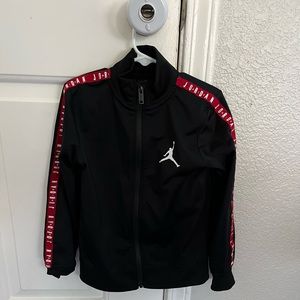 Size 6. Boys Jordan Zip Jacket. Black. Red trim. Gently used.